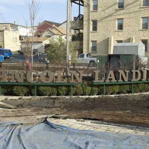 Installation of 'Lincoln Landing' sign near 8th street